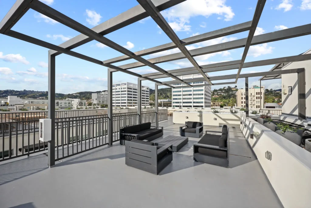Professional apartment rooftop photography featuring outdoor lounge seating, rooftop deck amenities, city views, and modern multifamily living spaces